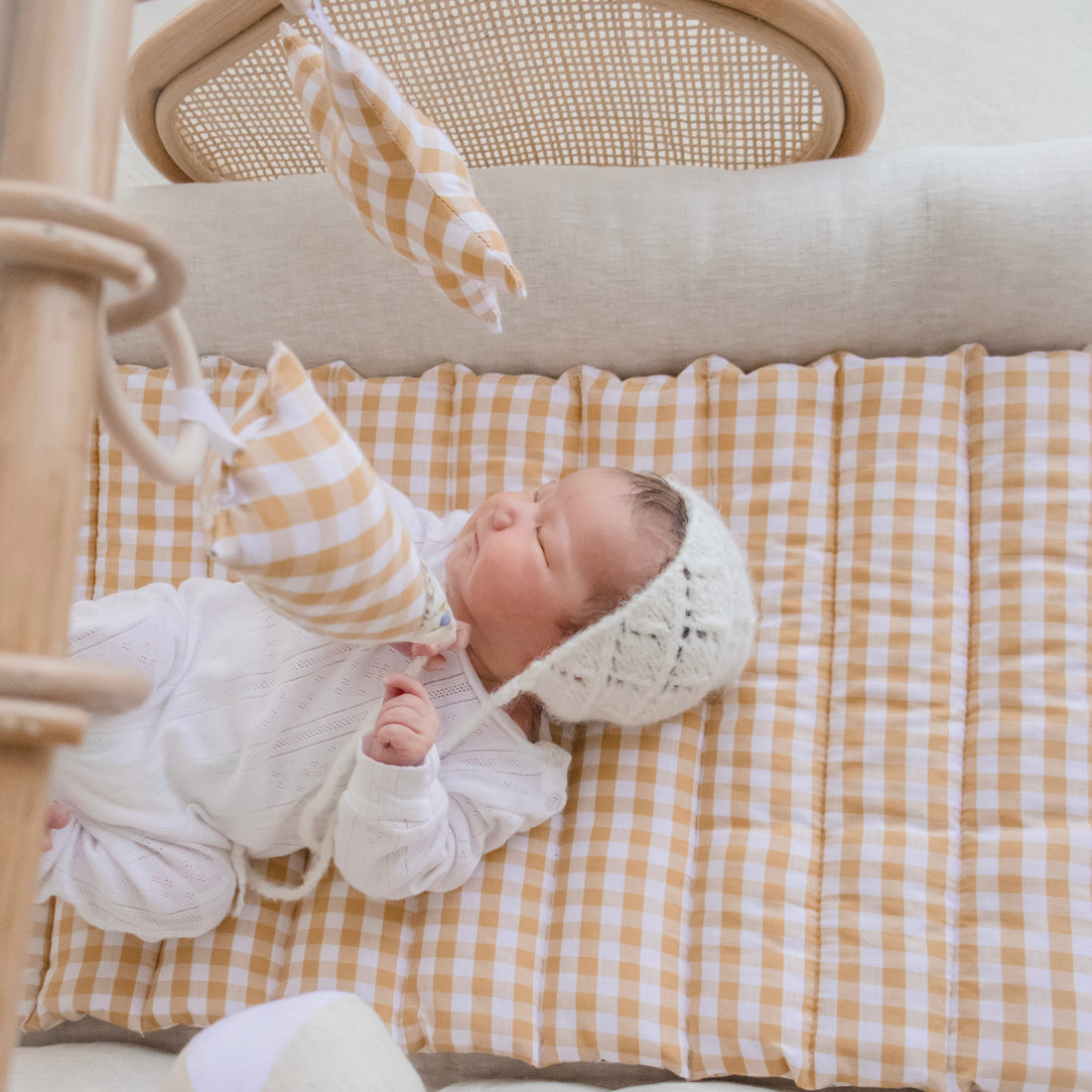 Newborn Baby Resting On Stina's Style Rattan Play Gym